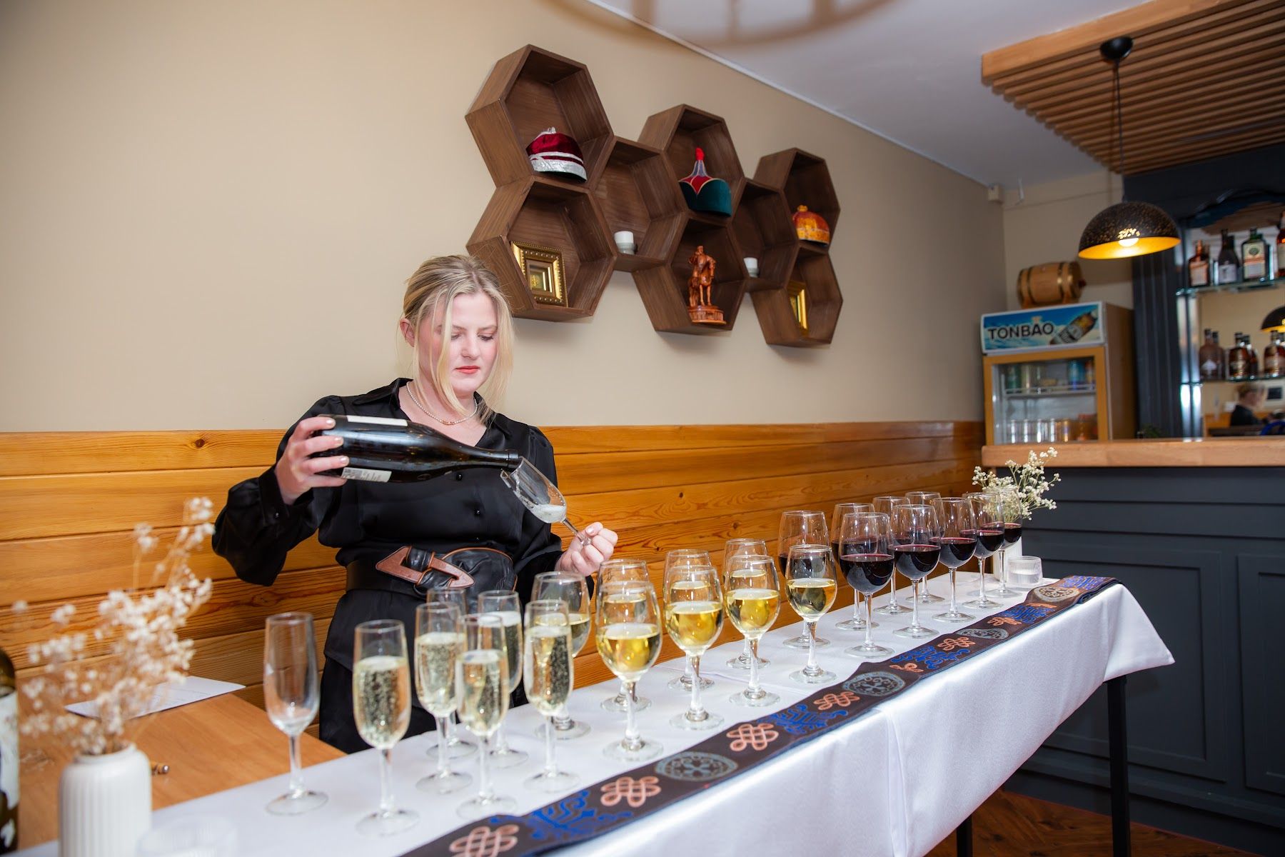 Champagne glasses on a table dressed in Mongolian textiles