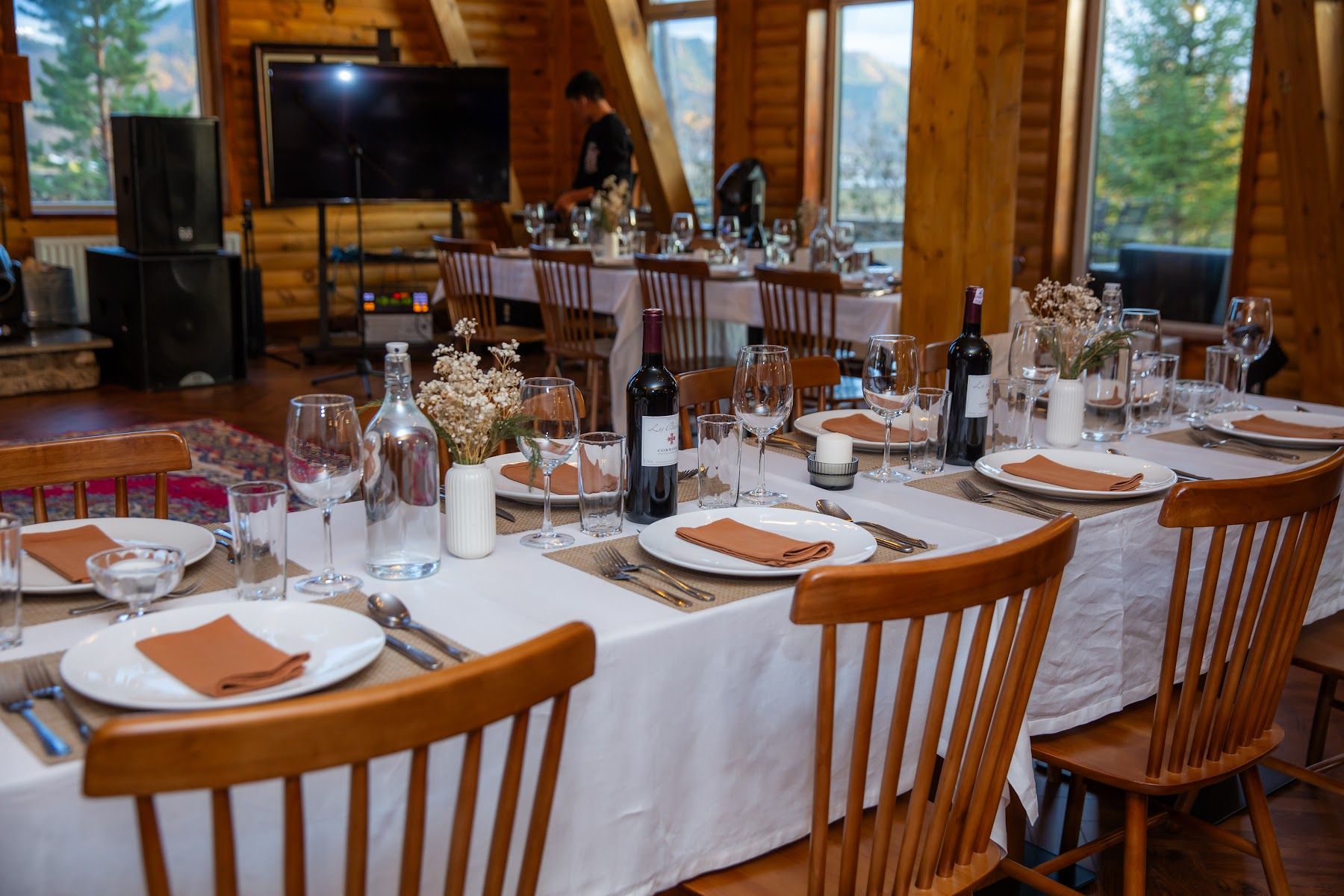 Tables set for a company dinner in the great hall at Big Sky Lodge