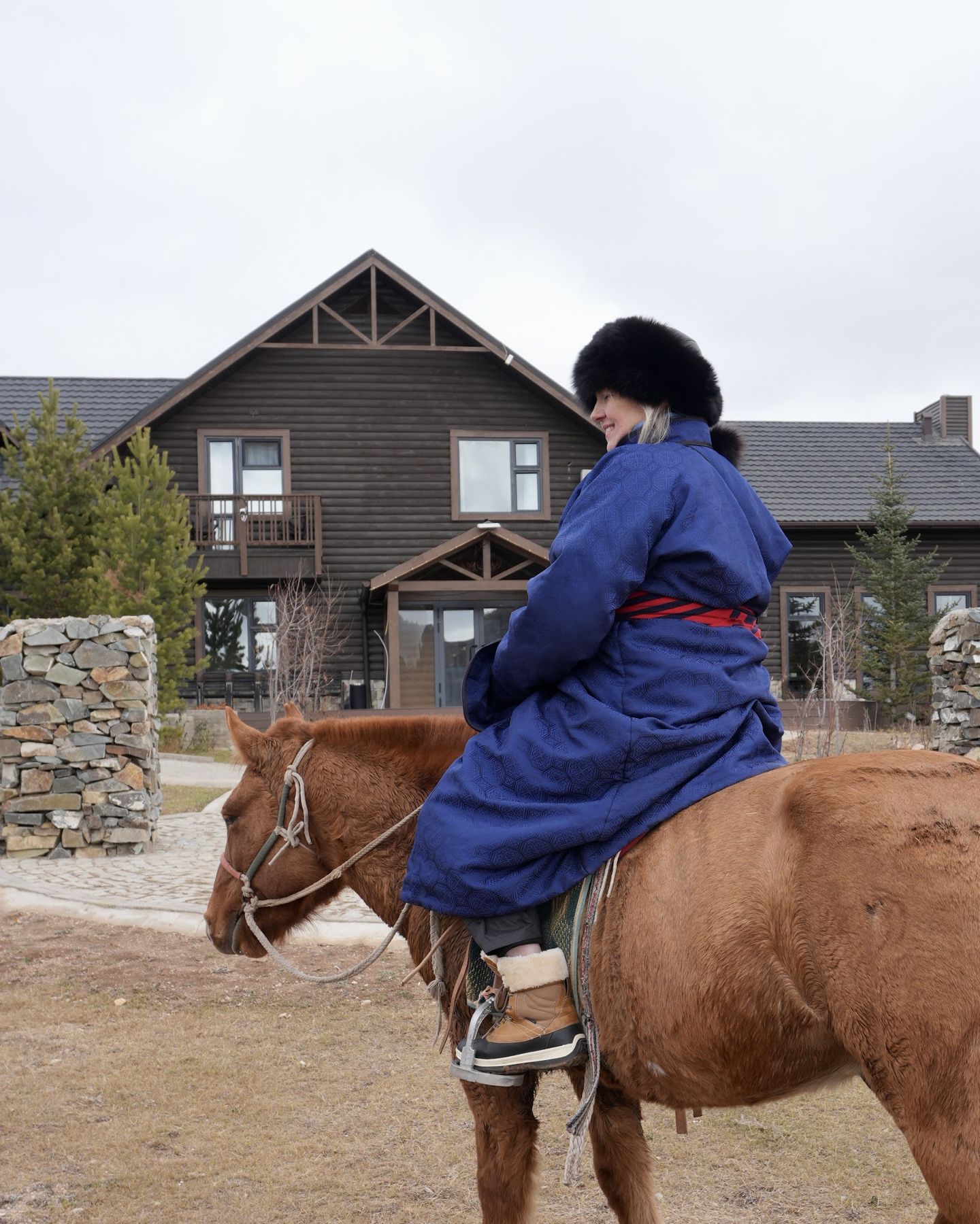 A guest in a deel riding past the lodge