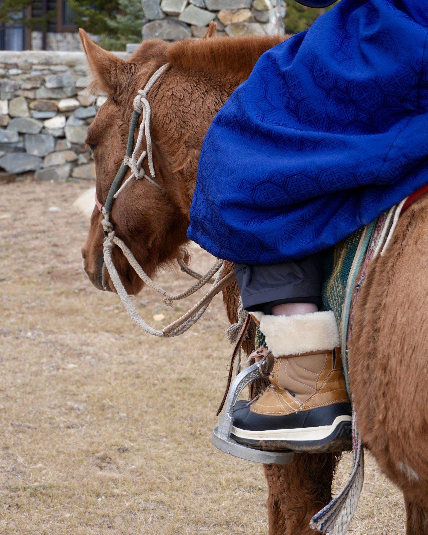 A guest in a deel riding past the lodge