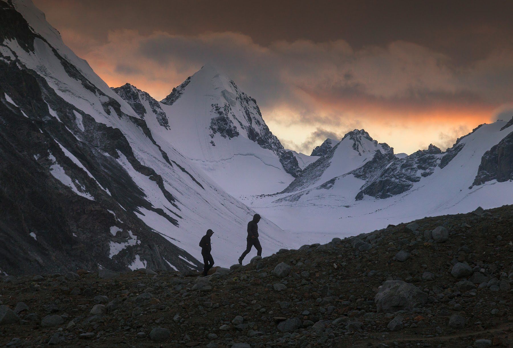 Walkers on a ridge at sunset